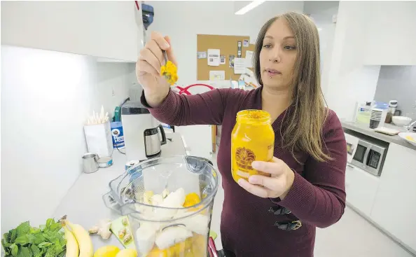  ?? PHOTO BY JASON PAYNE/ PNG ?? Nareena Switlo, chief operations officer for Naledo Food and Beverages, uses turmeric paste while preparing a smoothie at the company’s offices at UBC in Vancouver. “This is the first wild crafted turmeric paste in the world,” said Switlo.