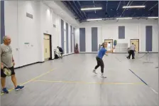  ?? Rachel Dickerson/The Weekly Vista ?? POA members play pickleball in the arena at the Recreation Center, located at 3 Riordan Drive.