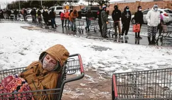  ?? Tamir Kalifa / New York Times ?? Camilla Swindle, 19, rests in a shopping cart as she and her boyfriend wait to enter a grocery store in Austin on Tuesday after the storm plunged Texas into crises of power, heat, water and food.