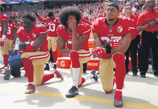  ?? Picture / AP ?? San Francisco 49ers Eli Harold ( left) and Eric Reid ( right) join Colin Kaepernick in taking a knee in protest while the national anthem is played.