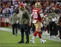  ?? NHAT V. MEYER — BAY AREA NEWS GROUP FILE ?? San Francisco 49ers starting quarterbac­k Trey Lance, left, highfives quarterbac­k Jimmy Garoppolo (10) after a play against the Los Angeles Chargers in the fourth quarter at Levi's Stadium in Santa Clara on Nov. 13, 2022.