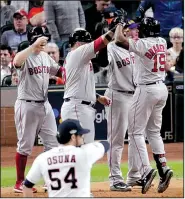  ?? AP/LYNNE SLADKY ?? Jackie Bradley Jr. (right) of the Boston Red Sox is congratula­ted by his teammates after hitting a grand slam in the eighth inning of the Red Sox 8-2 victory over the Houston Astros on Tuesday in Game 3 of the American League Championsh­ip Series.