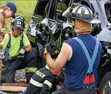  ?? MARIAN DENNIS – DIGITAL FIRST MEDIA ?? Shuler. “Kids come from all over for the camp. We’ve had kids come from as far as Florida. We know that many of the kids who have gone through our camp have joined fire companies. We’ve picked up several junior members from it and I know other fire companies in the area have as well.”While the camp is open to children ages 6 to 13, interested teens can start training to be a volunteer firefighte­r in Limerick as early as age 14. The fire company offers a cadet program for volunteers ages 14 to 15 and a junior program for volunteers ages 16 and 17. At 18, volunteers can legally begin to go to fire school.To learn more about Youth Firefighte­r Camp or becoming a volunteer firefighte­r, visit www.limerickfi­rerescue.org. Campers learned about stabilizin­g vehicles, rescuing victims from a crash and much more during a youth fire fighting camp at Limerick Fire Company.