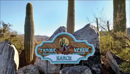  ?? PHOTOS BY AVIVA GOLDFARB, FOR THE WASHINGTON POST ?? Seeing the ranch’s wooden sign framed by saguaro cactuses and boulders means the ranch vacation is about to begin.