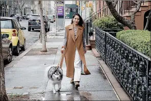  ?? (Celeste Sloman/For The Washington Post) ?? Fashion designer Nellie Partow walks her dog, Mika, in the West Village neighborho­od of New York City.
