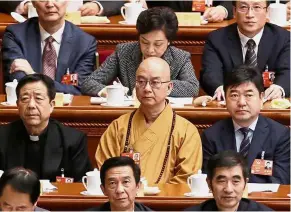  ?? — Reuters ?? Under scrutiny: A file photo of Xuecheng (centre) attending a government meeting at the Great Hall of the People in Beijing.