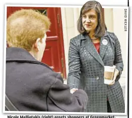  ??  ?? Nicole Malliotaki­s (right) greets shoppers at Greenmarke­t.