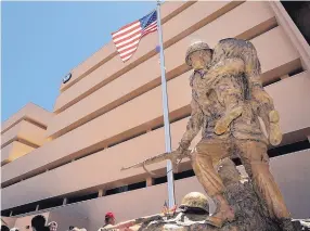  ?? JIM THOMPSON/JOURNAL ?? The statue of Medal of Honor recipient Capt. Raymond G. Murphy stands in front of the Veterans Affairs hospital in Albuquerqu­e named in his honor.