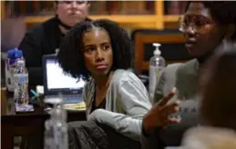  ?? ?? Burke junior Justis Porter, 18, (center) listened to Blessing Adedeji at the 826 Boston education center.