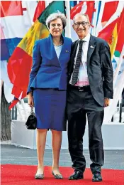  ??  ?? Theresa May with her husband Philip on the red carpet in Hamburg yesterday