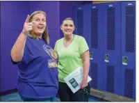  ??  ?? Jamie Austin, left, president of Poyen’s Parent Athletic Committee, and member Autumn Wilfong look over the amenities of the boys locker room inside the new Poyen Sports Complex on Nov. 30.