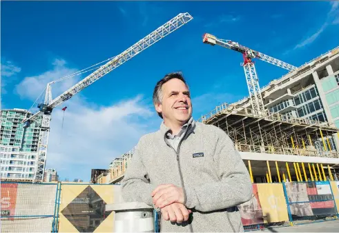  ?? GERRY KAHRMANN ?? North Vancouver Mayor Darrell Mussatto observes the ongoing redevelopm­ent of the Shipyards area on the city’s waterfront.