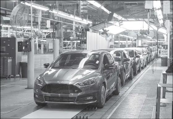  ?? AFP ?? Photo shows a lineup of Ford Focus vehicles at the Ford Michigan Assembly Plant in Wayne, Michigan. US manufactur­ers showed firm signs of life in October after a mid-year slowdown, but overall industrial output was lower due to the energy sector slump,...