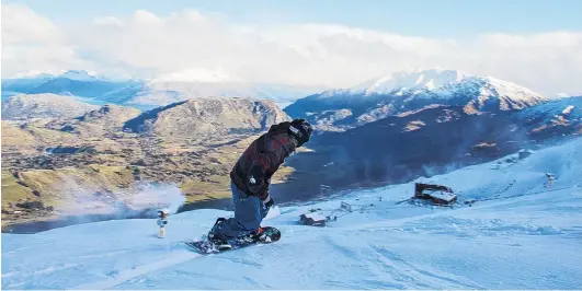  ?? PHOTO: NZSKI ?? Fresh powder . . . A snowboarde­r enjoys the new snow on the slopes of Coronet Peak skifield.