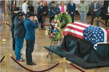  ?? ERIC LEE/POOL VIA AP ?? Veterans from Texas pay their respects at the casket of Hershel W.“Woody”Williams on Thursday in the U.S. Capitol. Williams, a 5-foot-6 former Marine, was described by House Speaker Nancy Pelosi as a “force of nature” during the Battle of Iwo Jima. The last remaining Medal of Honor recipient from World War II, Williams died June 29 at age 98.