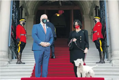  ?? CHAD HIPOLITO CANADIAN PRESS ?? Premier John Horgan greets Lt.- Gov. Janet Austin and her dog Macduff on the steps of the legislatur­e as she arrived to deliver the government’s throne speech on Monday. Ceremonial events were largely scaled back due to pandemic restrictio­ns.