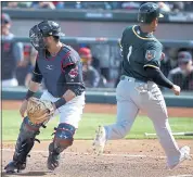  ?? ROSS D. FRANKLIN — THE ASSOCIATED PRESS ?? Franklin Barreto of the A’s crosses the plate before Cleveland catcher Yan Gomes receives the throw Tuesday.