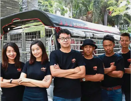  ??  ?? Providing a way: Soe Pyae Aung (third from left) and his team connect fleet operators and small businesses to meet logistic needs. — The Nation