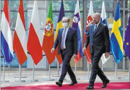  ?? Yves Herman The Associated Press ?? Kosovo’s Prime Minister Avdullah Hoti, left, is welcomed by European Council President Charles Michel prior to a meeting Thursday at the Europa building in Brussels.