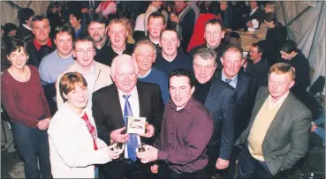  ?? ?? Special guest Sean Donnellan with a little help from Caroline Lynch (singer) and musical director John O’Donovan, launching the Araglin Album in O’Mahoney’s Marquee in March 2002. Also present are those who helped in making the album and some performers, l-r: Bridget Leddy-Hunt, Tom Shanahan, Mike Lynch, Kieran Leddy, Mick Daly, (Ballinamad­ock), Tony Dunne, John Leddy, Aidan Leddy, Tom Leddy, Mike Hoye, Con Leddy, Mike Lyons and Frank Lomasney.