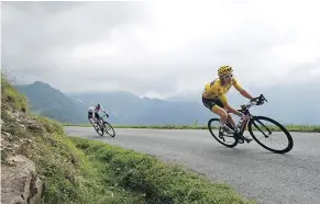  ?? — THE ASSOCIATED PRESS ?? Britain’s Geraint Thomas is followed by teammate Chris Froome, also of Britain, on Col de Val Louron-Azet pass during the 17th stage of the Tour de France on Wednesday.