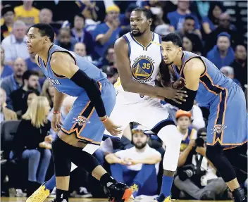  ?? AP ?? Oklahoma City Thunder guard Russell Westbrook (left) and Andre Roberson (right) guard Golden State Warriors’ Kevin Durant (35) during the first half of an NBA basketball game on Thursday in Oakland, California. Golden State won 122-96.