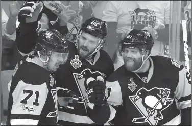  ?? AP/GENE J. PUSKAR ?? Pittsburgh’s Ron Hainsey (center) celebrates his goal with teammates Evgeni Malkin (left) and Phil Kessel on Thursday during Game 5 of the NHL hockey Stanley Cup Finals against the Predators in Pittsburgh.