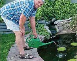  ??  ?? Critical: Barry Davies tops up his pond with a watering can