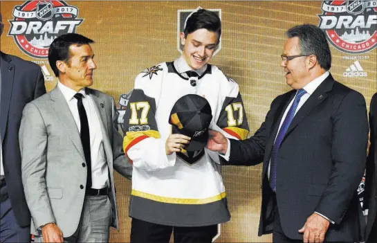  ?? David Banks ?? USA Today The Golden Knights’ first pick, center Cody Glass, is congratula­ted by general manager George Mcphee, left, after being taken sixth overall in the NHL Entry Draft.