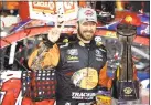  ?? Jeff Siner / TNS ?? Martin Truex Jr. celebrates after winning the CocaCola 600 at Charlotte Motor Speedway in Concord, N.C. on Sunday.