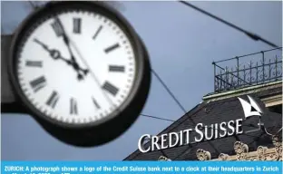  ?? ?? ZURICH: A photograph shows a logo of the Credit Suisse bank next to a clock at their headquarte­rs in Zurich on March 19, 2023. — AFP