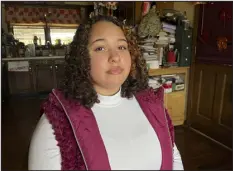 ?? PATRICK ORSAGOS — THE ASSOCIATED PRESS ?? Mia Woodard, who had hoped to be the first in her family to get a college degree, now works at a restaurant. “It’s still kind of 50- 50,” she said of college.