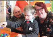  ??  ?? Cathal Kelly on his first day at Scoil Iosagain, Mallow with parents Sean and Lisa. Photo: Eugene Cosgrove