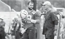  ?? MICHAEL CONROY/ASSOCIATED PRESS ?? Quarterbac­k Andrew Luck, left, chats with first-year Colts coach Frank Reich at practice Thursday. “I’ve really enjoyed talking to him, learning from him,” Luck said.