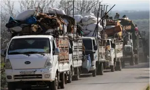  ?? (Khalil Ashawi/Reuters) ?? PEOPLE FLEE with their belongings in Syria’s northeaste­rn Afrin region yesterday.