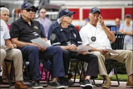  ??  ?? Left: Retired New York Police Department members attend a 9/11 Remembranc­e Ceremony on Tuesday at the Patriot Memorial in Wellington,