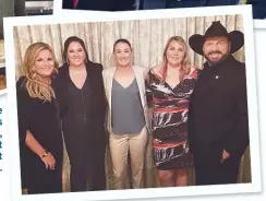  ??  ?? The couple with Garth’s
daughters, Allie, August and Taylor, last
March.