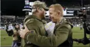  ?? MATT SLOCUM — THE ASSOCIATED PRESS ?? Philadelph­ia Eagles’ Doug Pederson, left, and Dallas Cowboys’ Jason Garrett meet after an NFL football game, Sunday.