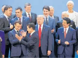  ?? Photo / AP ?? The G20 leaders committed to a “rules-based internatio­nal order”, despite the rejection by Donald Trump (centre) of many rules.