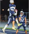  ?? MATT BATES — ENTERPRISE-RECORD ?? Bryson McFall (23) lifts Noah Thomas (2) into the air as
Bryson Snelling (32) celebrates a touchdown by Thomas on Sept. 3 at Asgard Yard in Chico.