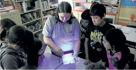  ?? HANDOUT ?? Inuit research associate Inez Shiwak, centre, shows students of Northern Lights Academy, in Rigolet, N.L., how the research team tested water for coliform bacteria and E. coli in an undated handout photo. Researcher­s studying higher rates of...