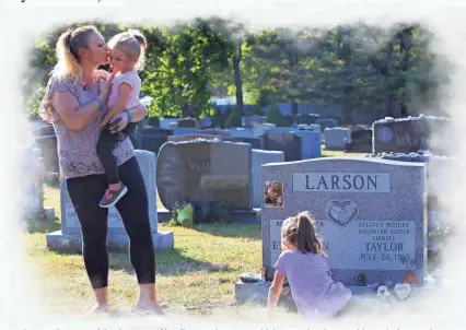  ?? ANDREW FORD/USA TODAY NETWORK ?? Taylor Bromberg, 26, visits the grave of her fiance, Eric Larson, with her two daughters, Adriana Nicole, 5, and Mikayla Grace, 2. Larson was killed in New Jersey in 2018 by a suspect fleeing police.