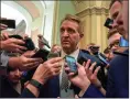  ?? Washington Post photo by Bill O’Leary ?? Sen. Jeff Flake, R-Ariz., is mobbed by reporters after emerging from a meeting with Senate leadership Friday.