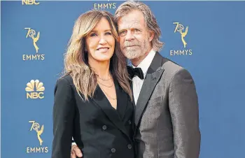  ?? MARCUS YAM TRIBUNE NEWS SERVICE ?? Felicity Huffman and husband William H. Macy in 2018. Huffman has been charged in a college admissions scandal after allegedly paying to have her daughter’s test scores inflated.