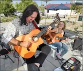  ?? ?? (Bottom) Carbe and Durand entertain at the Canyon Country Farmers Market grand opening.