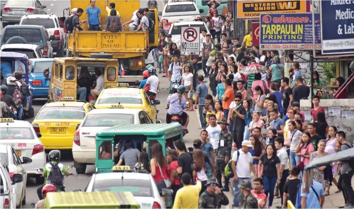  ?? MACKY LIM ?? TRANSPORT STRIKE. Stranded commuters affected by the transport strike yesterday wait to catch downtown bound jeepneys at Matina Crossing at around 7:45 a.m. With the difficulty of riding the tall dump trucks offered by the city government, only a few...