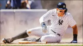  ?? Eduardo Munoz Alvarez / Associated Press ?? The Yankees' Aaron Judge watches the play after sliding to score a run during the eighth inning against the Rangers on Monday.