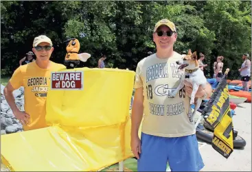 ??  ?? ABOVE: Tim Groves (right) and his dog stand by the SSN 21 Buzz along with Charlie Schroeder on Saturday at Dixon Landing before the start of Rome’s Big Float along the Etowah River.