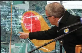  ?? GENE J. PUSKAR — THE ASSOCIATED PRESS ?? Ohio Governor Mike DeWine, in a visit to East Palestine, Ohio, points to a map of the community that indicates the area that has been evacuated as a result of the Norfolk Southern train derailment.