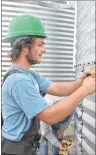 ?? MILLICENT MCKAY/JOURNAL PIONEER ?? Parker Leclair, works on a silo that will house seed at the New Leaf Essentials East plant in Slemon Park.